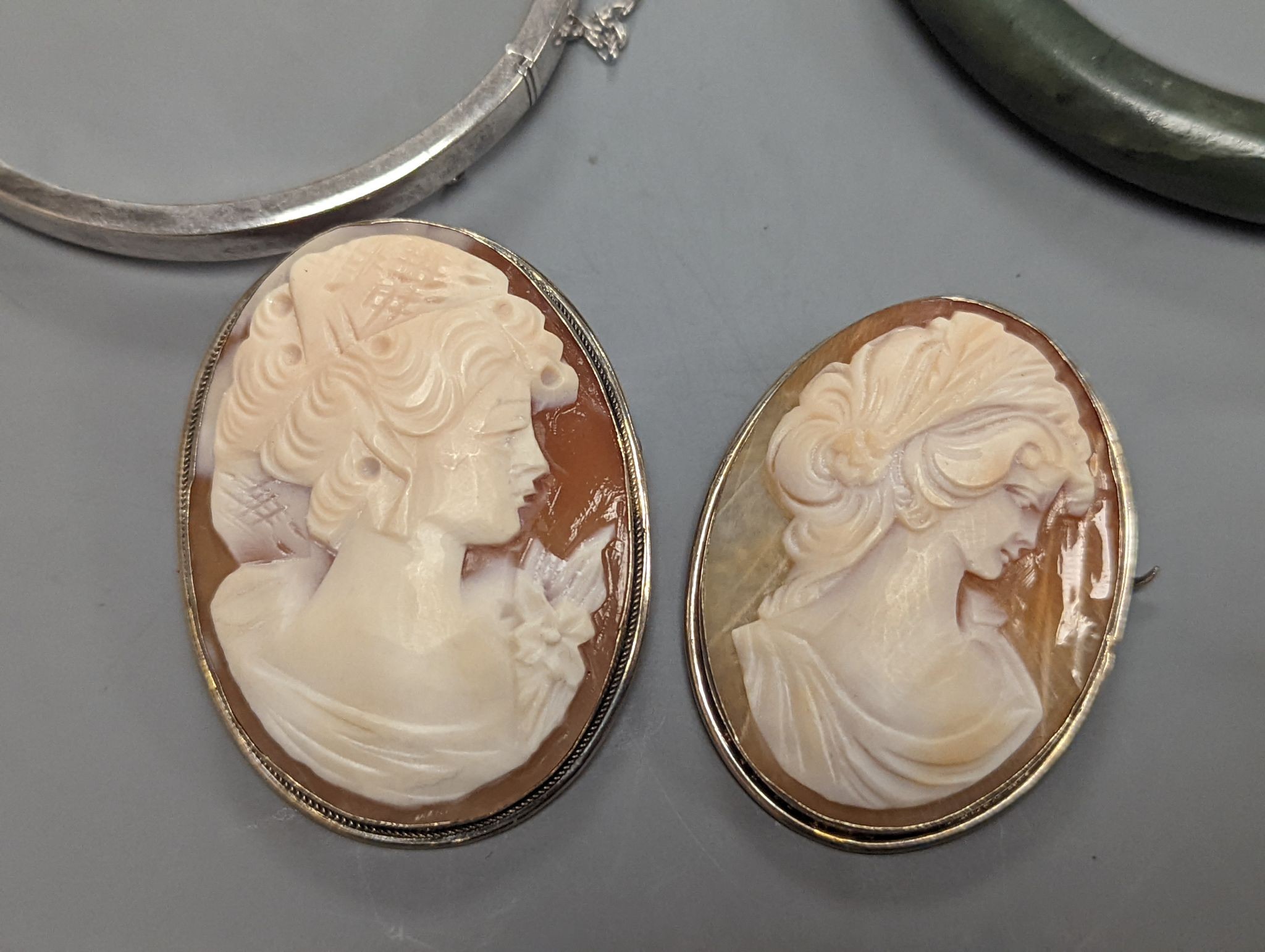 A 925 and hardstone set bracelet, 19.7cm, one other bracelet, two cameo shell brooches, three assorted bangles and a pair of sugar tongs.
